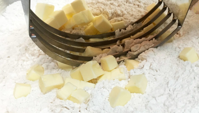 Cutting the butter into the flour.