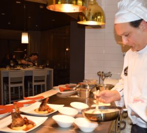 Serving braised lamb shanks and potato gnocchi in truffle cream