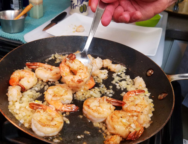 Quickly cook the shrimp and remove them from the pan.