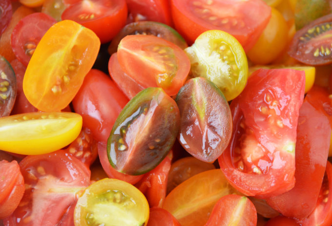 Slice all the tomatoes in half.