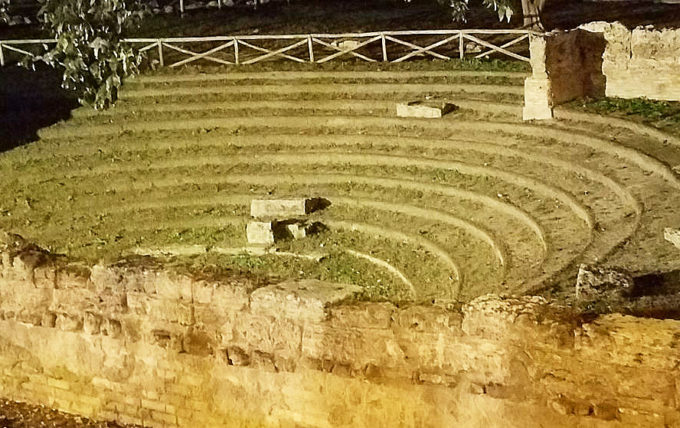 A night photo of the Paestum amphitheater.